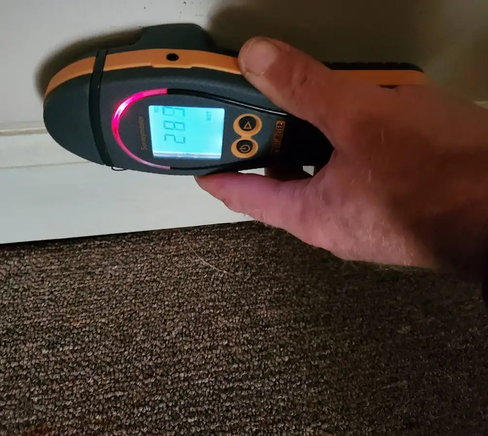 Moisture detection at baseboard during Storm Damage Restoration in Batesville